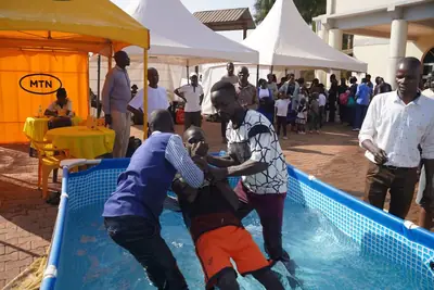 A baptism in the pool outside the church