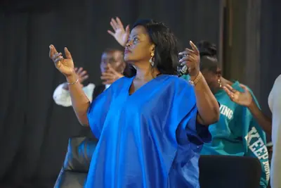 A woman worshipping with hands raised