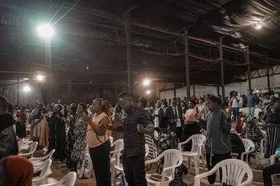 The crowd worshipping under the lights